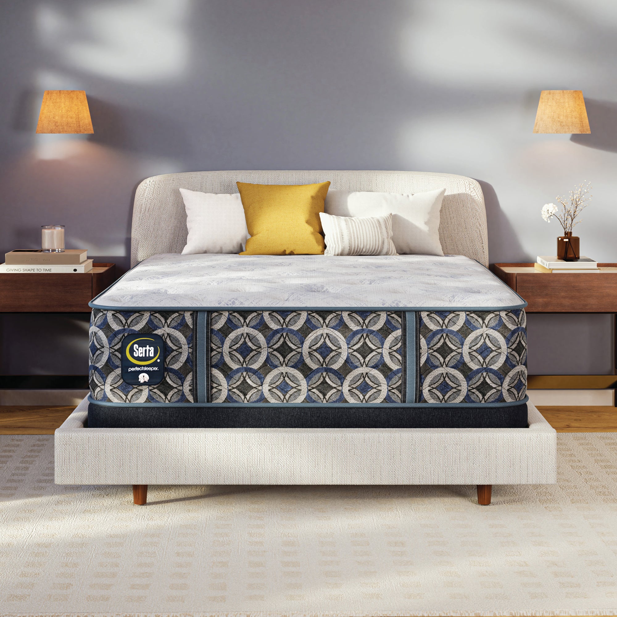 Serta perfect sleeper medium mattress on a bed in a bedroom setting with lamps and decor.