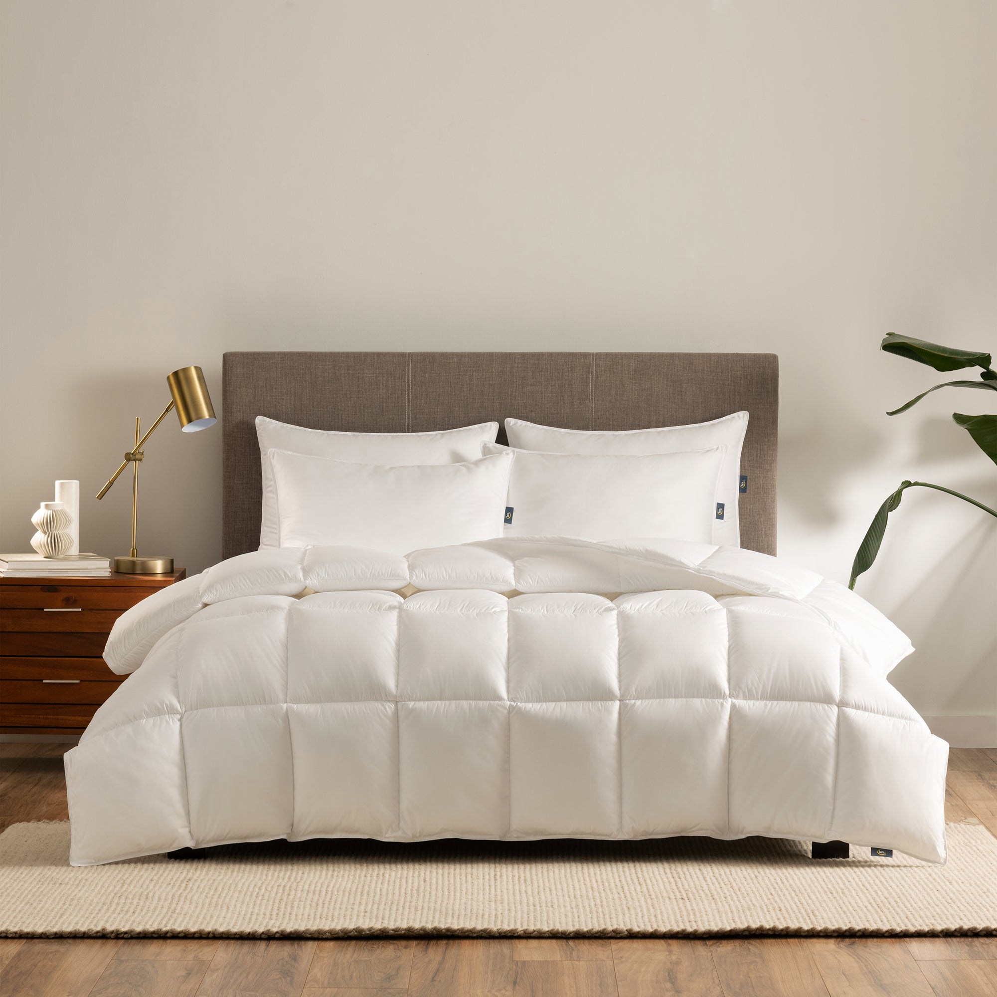 The Serta Down Illusion Down Alternative Comforter on a mattress