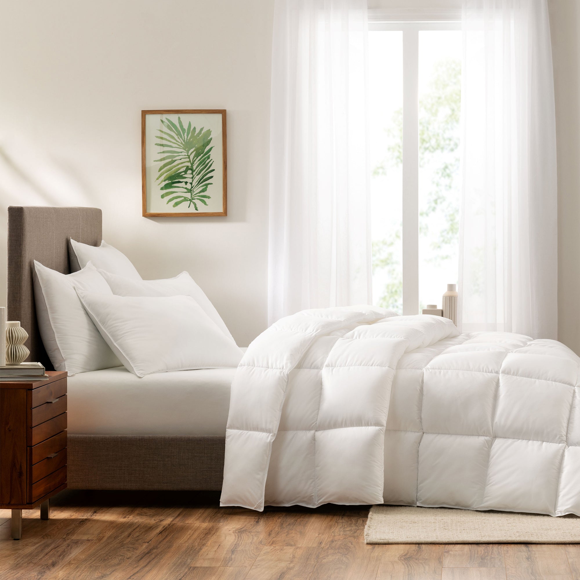 Serta Down Illusion Down Alternative Comforter on a mattress in a bedroom