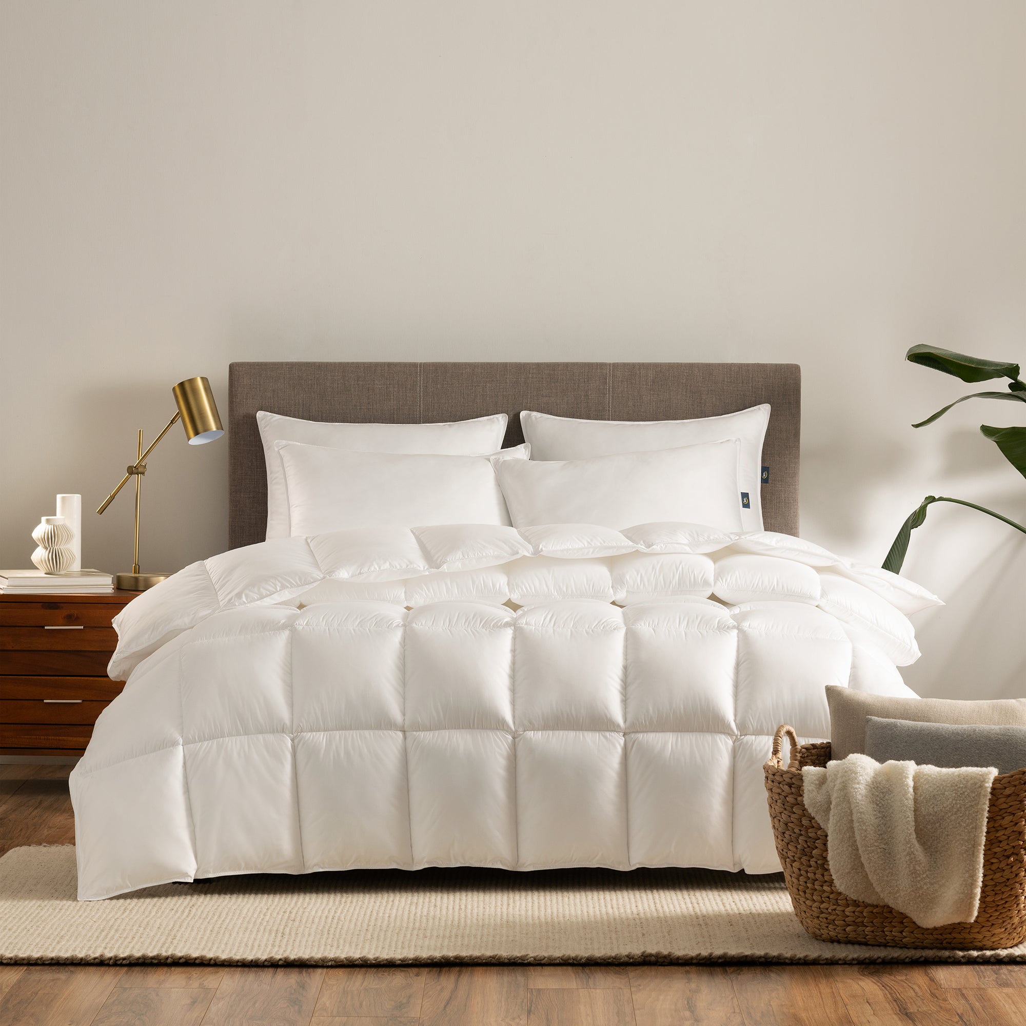 Serta Down Illusion Down Alternative Comforter - Extra Warmth draped on top of a mattress with 4 pillows on top of it in a bedroom setting.