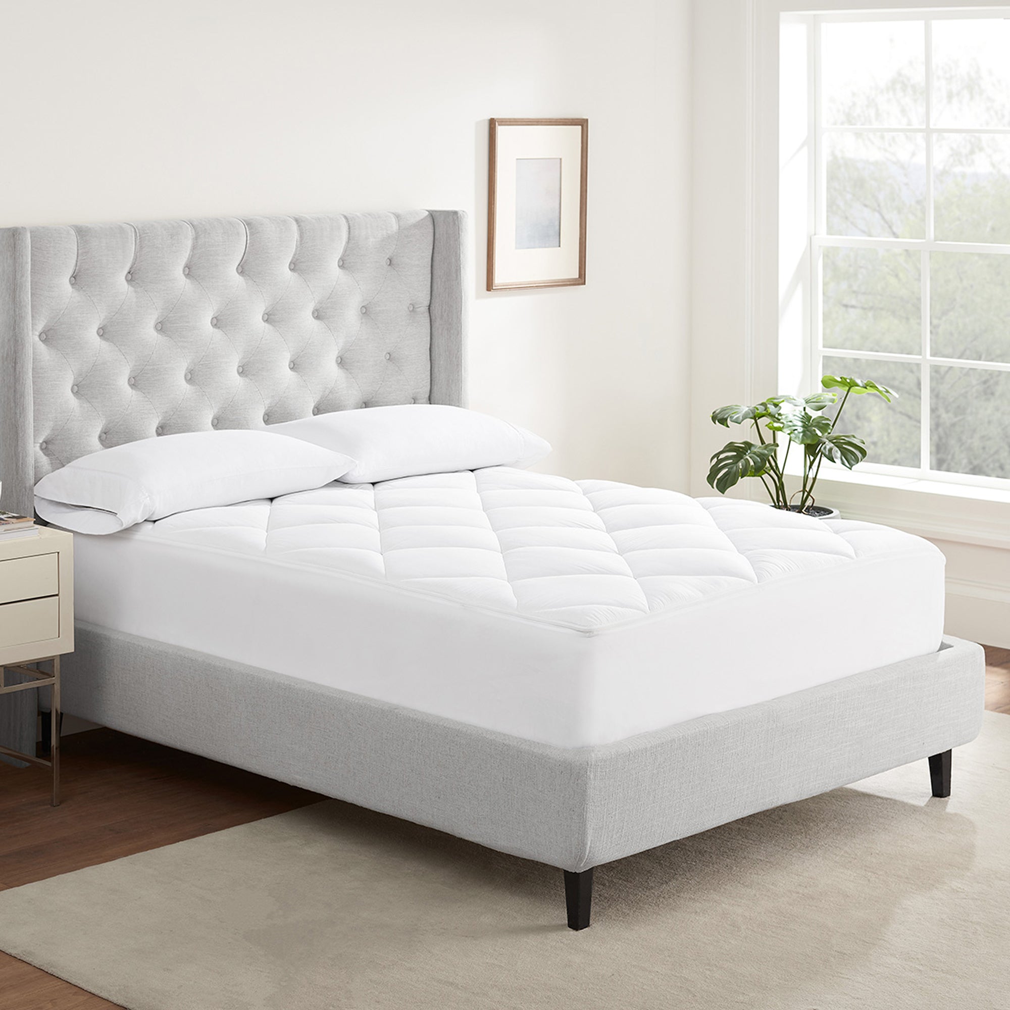 Serta Air Dry Extra Comfort Plus Mattress Pad on top of a mattress with 2 pillows on top.