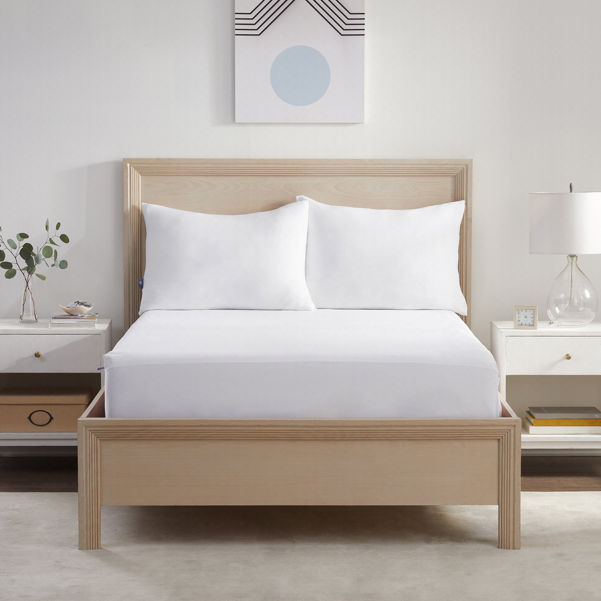 Serta Power Chill Mattress Protector wrapped over a mattress in a brown bed frame with 2 pillows on top of it.